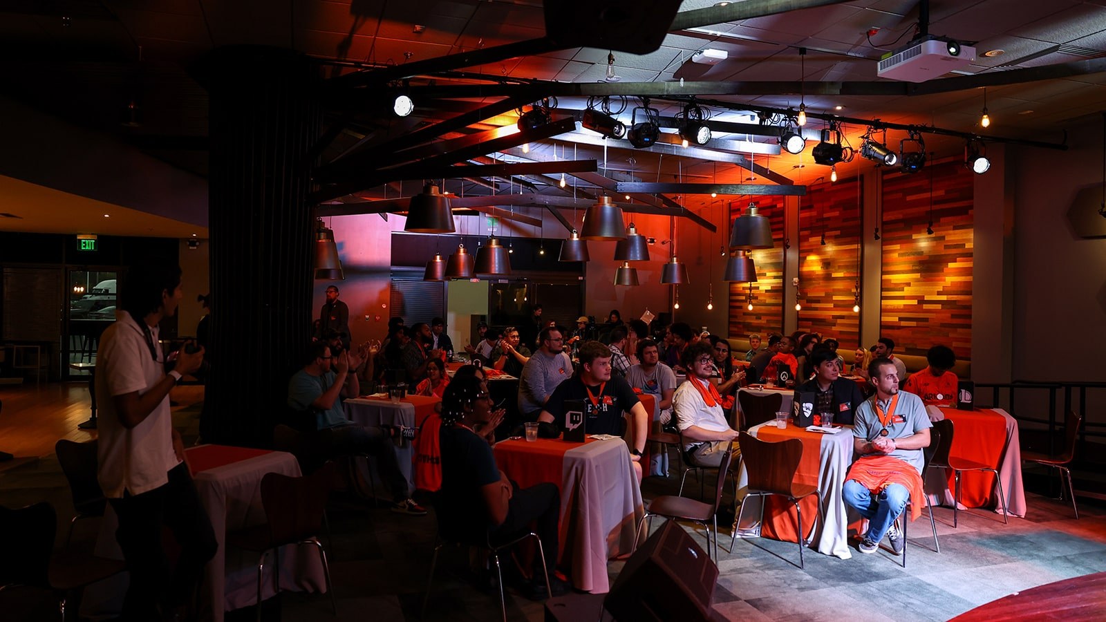 Members of the Full Sail Armada esports community gathered together in the Treehouse, many wearing their new orange jerseys.